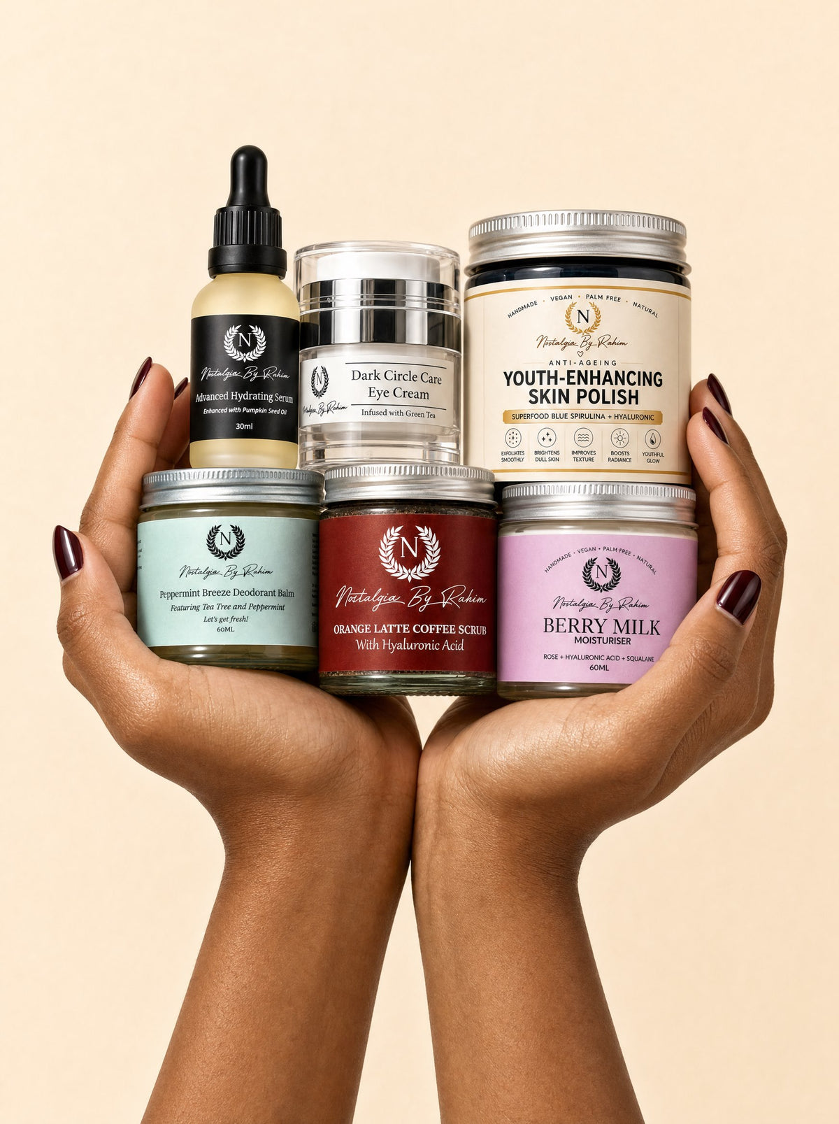 Two hands holding six Nostalgia By Rahim skincare products